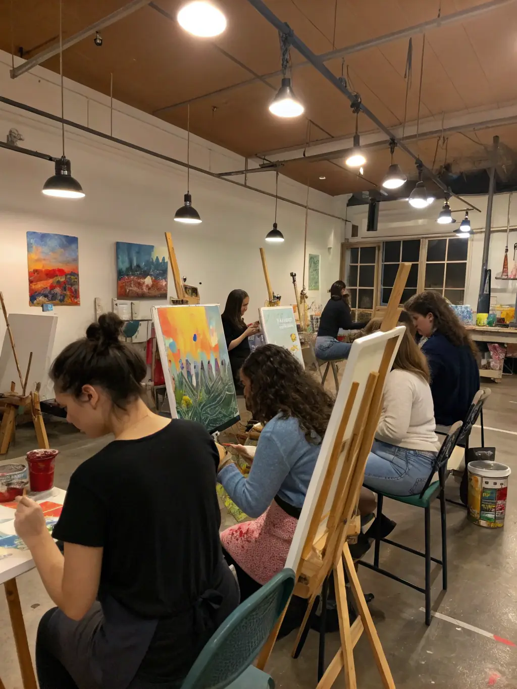 A vibrant image of a painting class at Musée Boucheix, featuring easels, canvases, and participants experimenting with colors and brushstrokes.